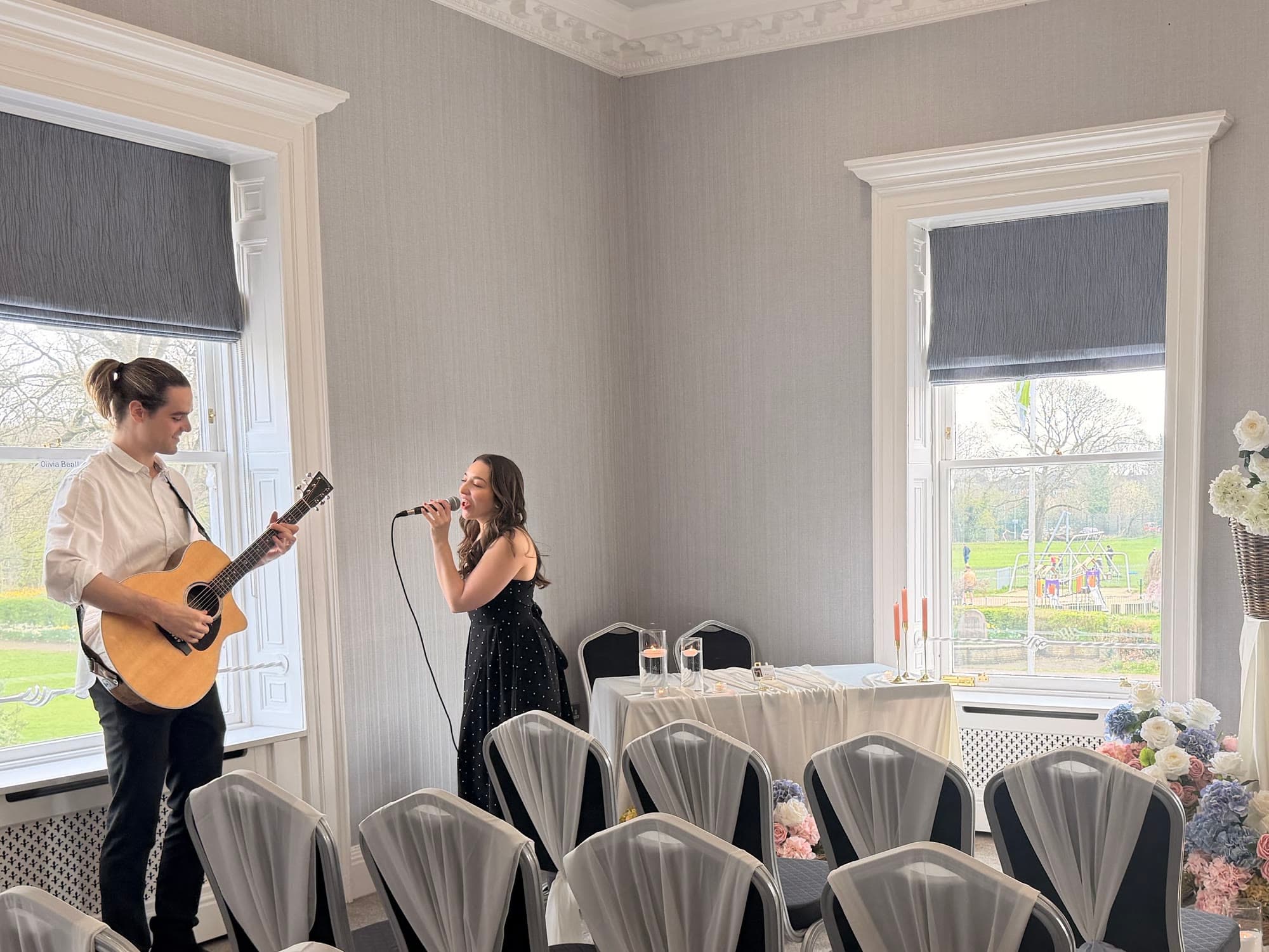Olivia and Danny performing at a wedding ceremony